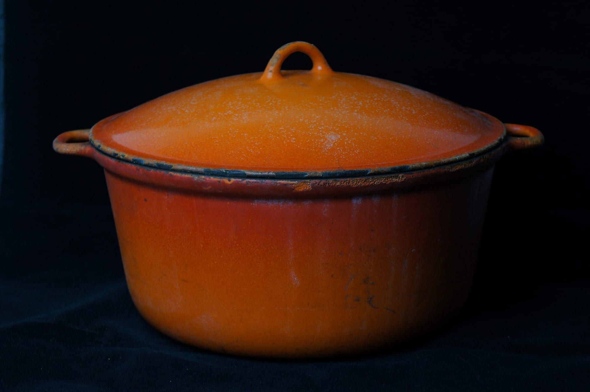 A cadmium-orange enamelled cast-iron pot
