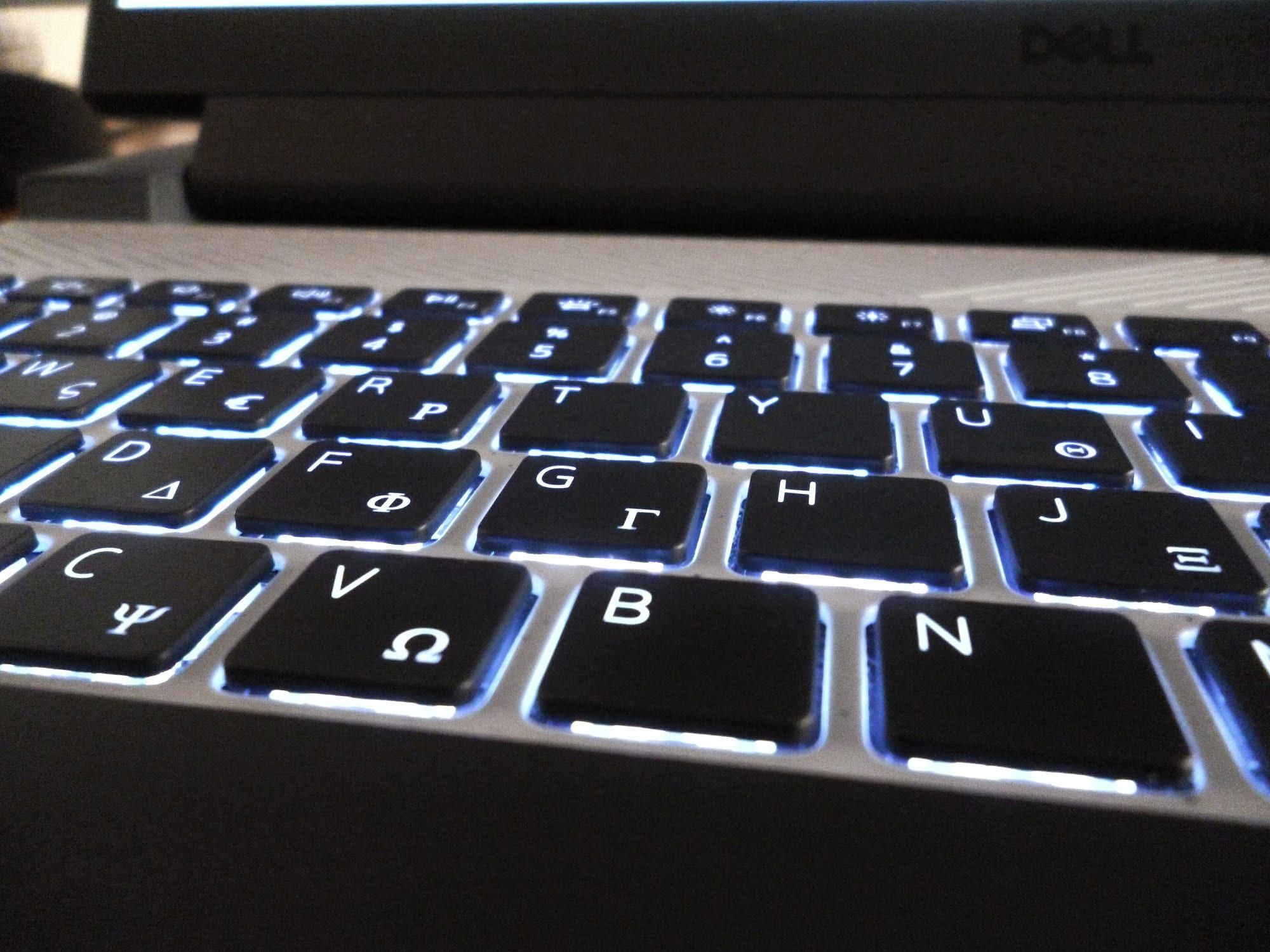 Close-up of a backlit laptop keyboard with glowing key edges