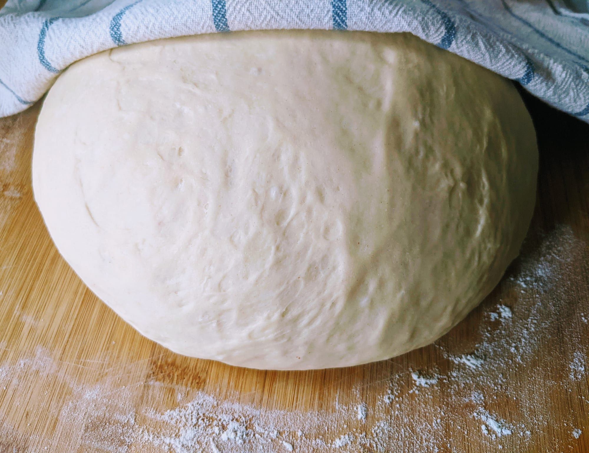 A bowl of risen bread dough ready to be shaped