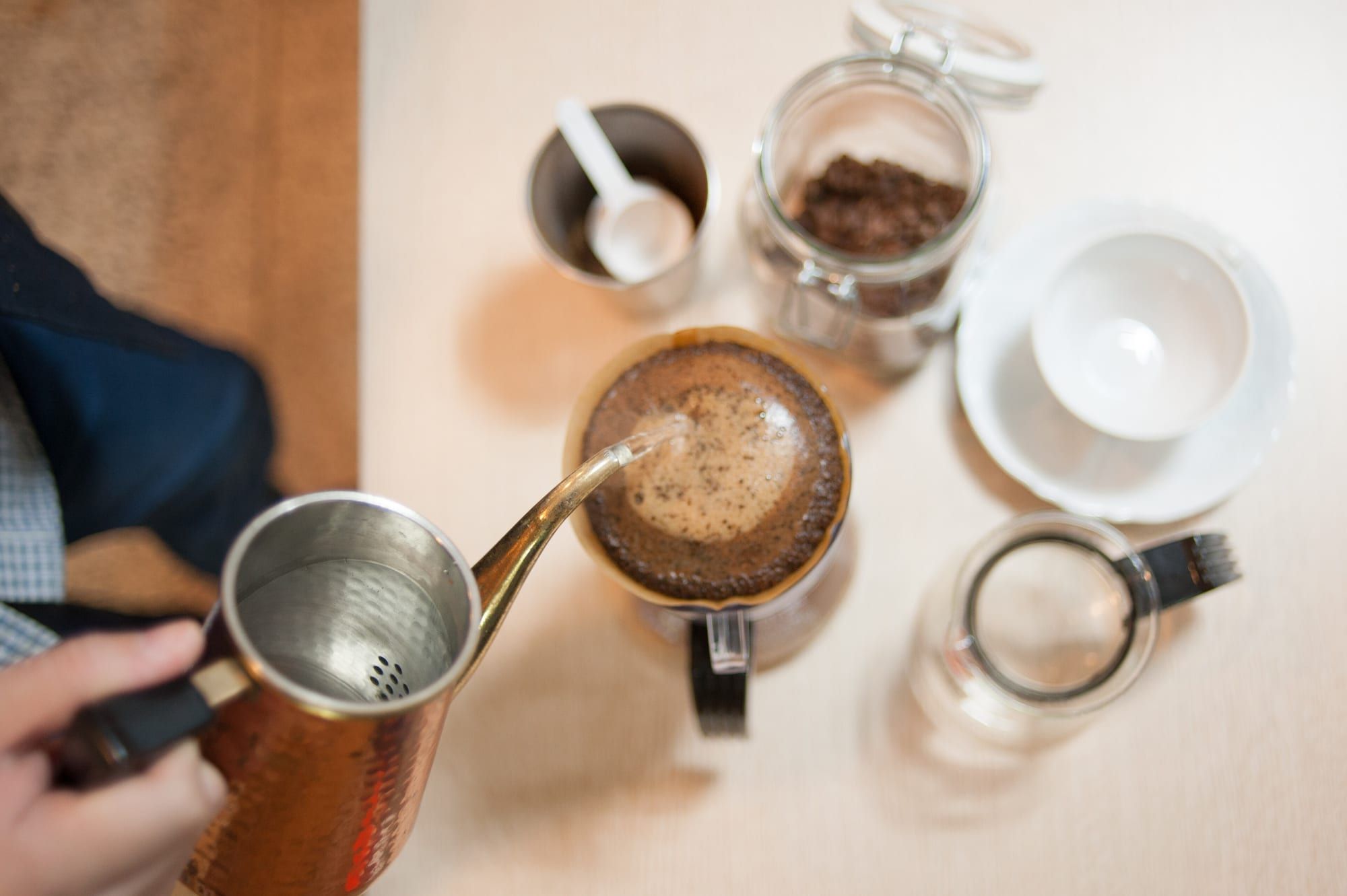 Hot water being poured over ground coffee in a manual drip filter